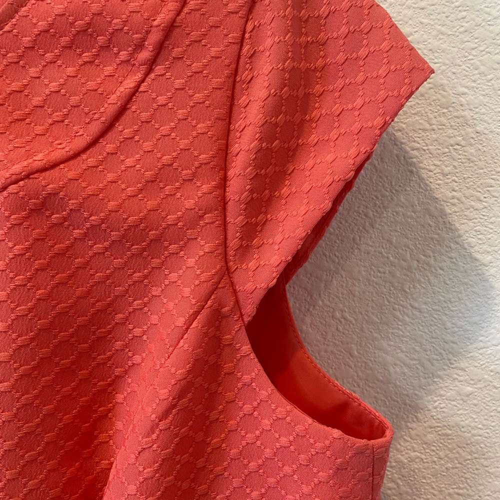Dress orange with little gold dots.